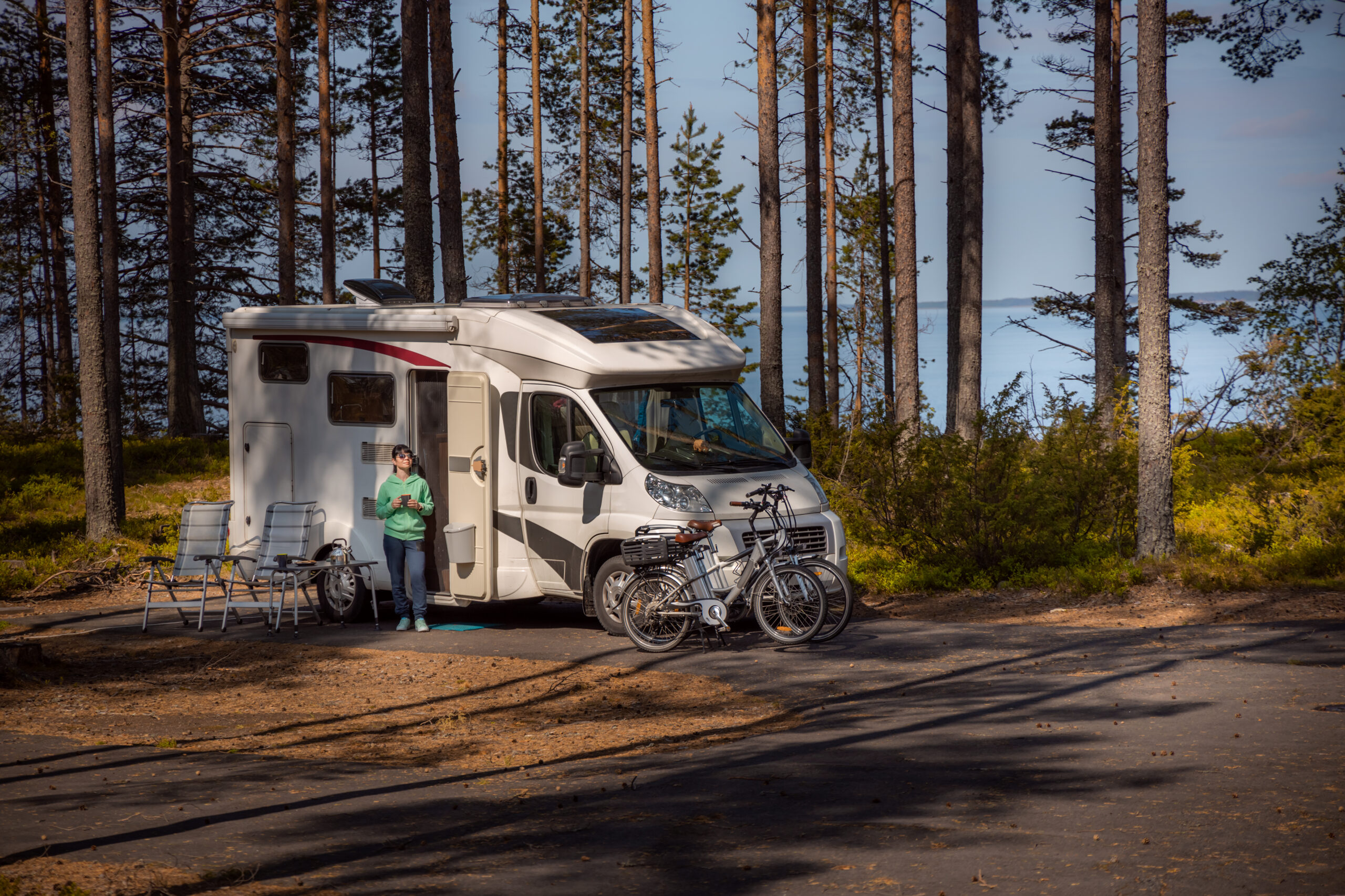 New vs Used Motorhome - Motorhome in forest with bikes